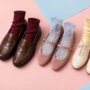 Four fall shoe-and-sock pairings featuring loafers, Mary Janes, lace-up flats, and sneakers with colorful ribbed, sheer, and frilled socks.